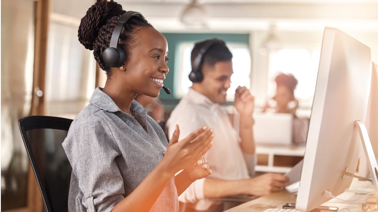 Woman smiling at computer working as customer rep
